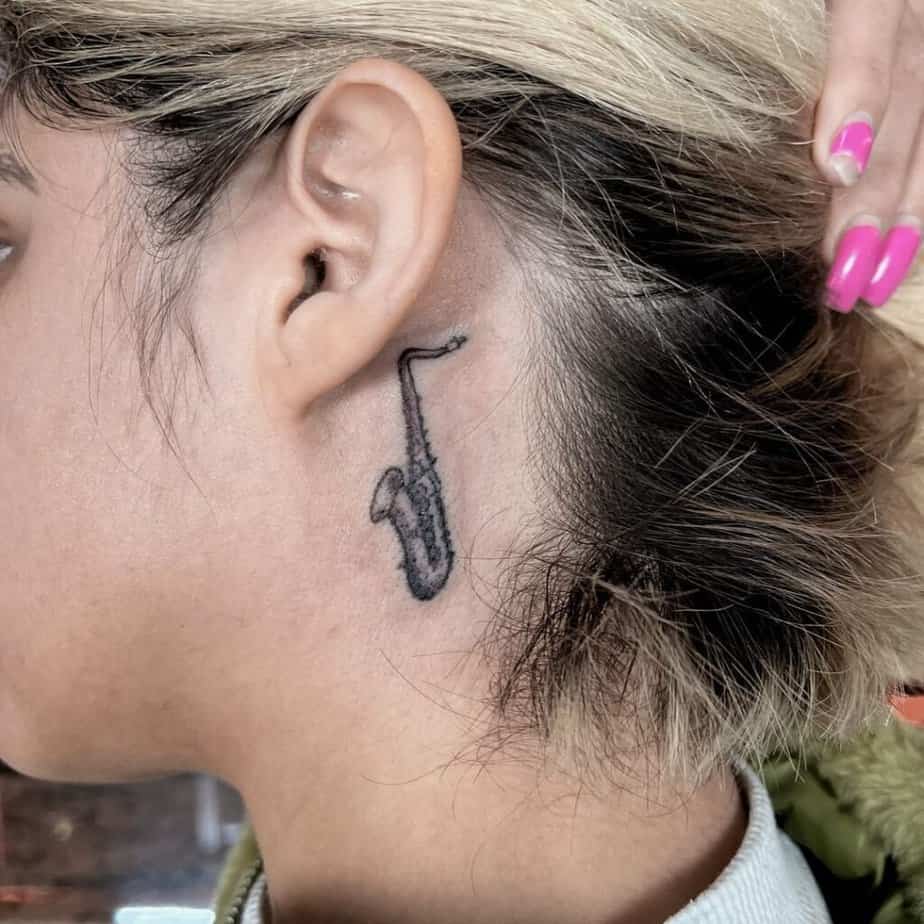 19. A behind-the-ear saxophone tattoo 