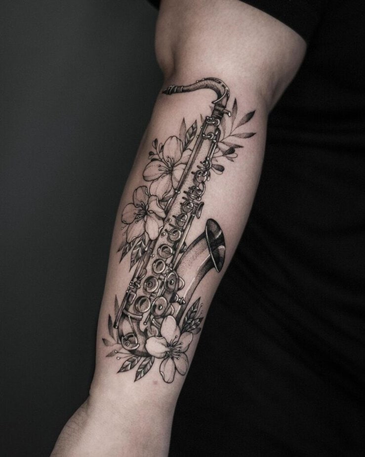 27. A saxophone tattoo with flowers 