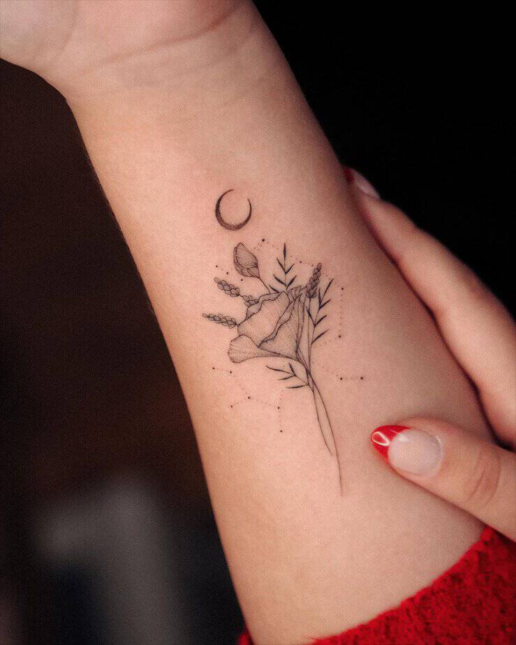 1. A Sagittarius tattoo with flowers and a moon
