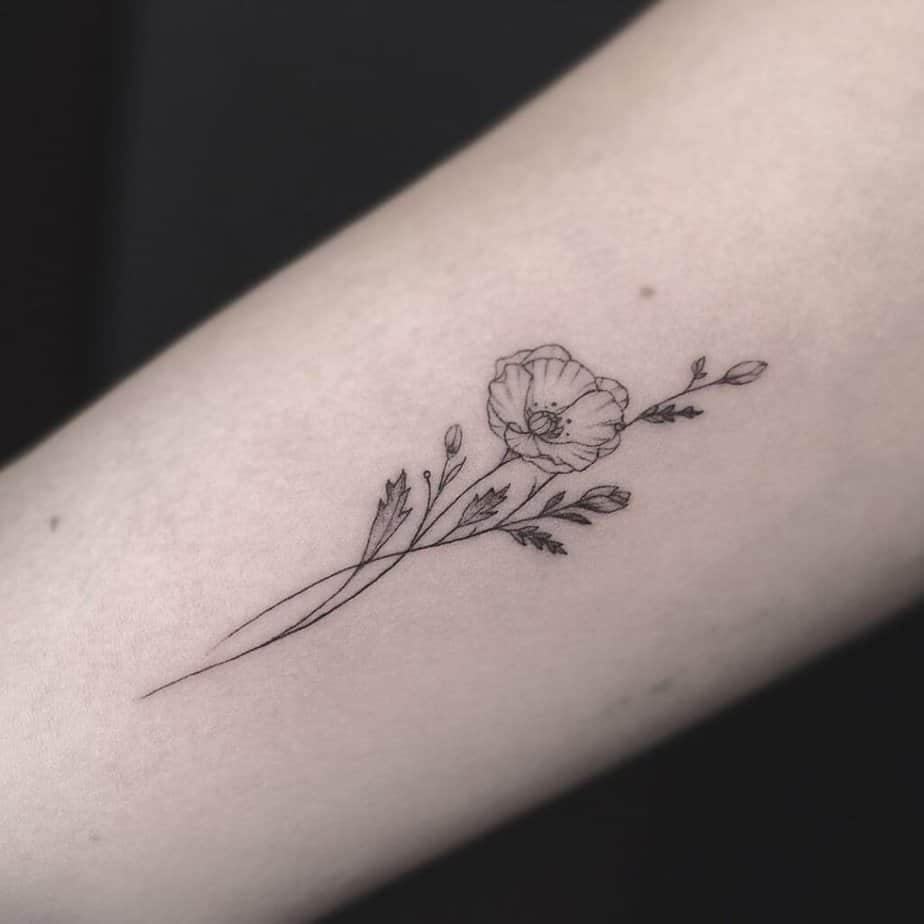 A black-and-white poppy flower tattoo