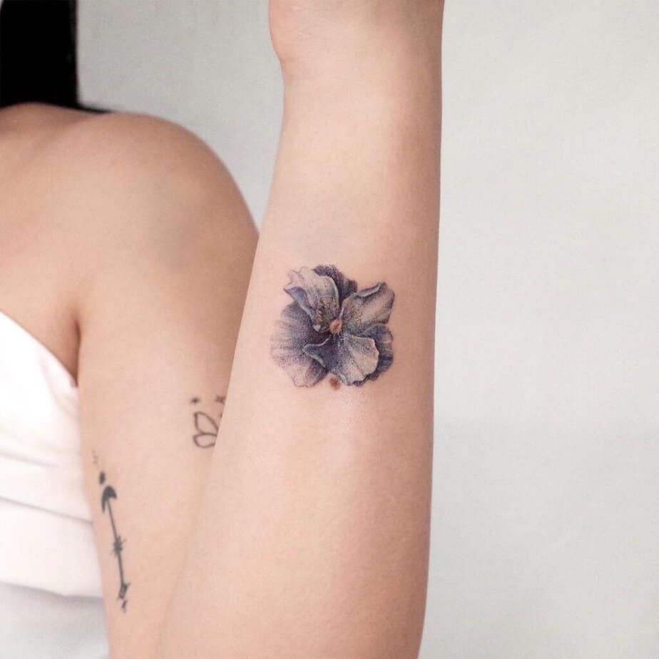 A blue poppy flower tattoo