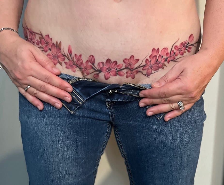 18. A cherry blossom tummy tuck tattoo
