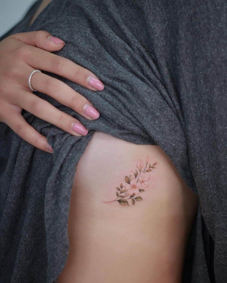 3. A colorful jasmine tattoo on the ribcage
