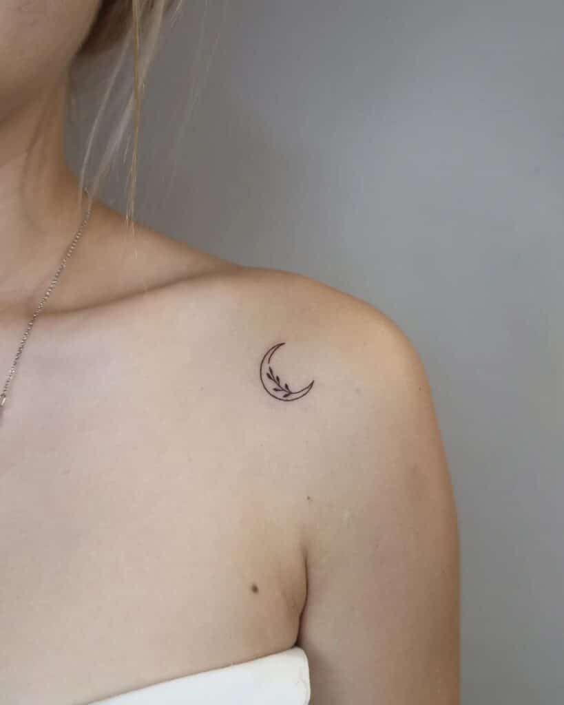 A crescent moon tattoo on the shoulder