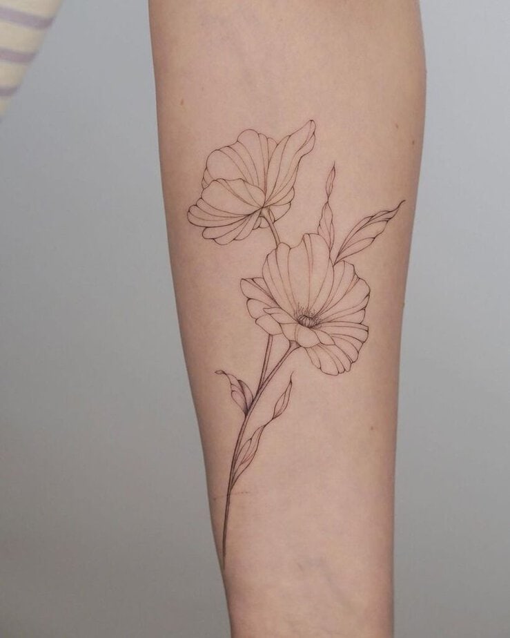 A delicate, dainty poppy flower tattoo