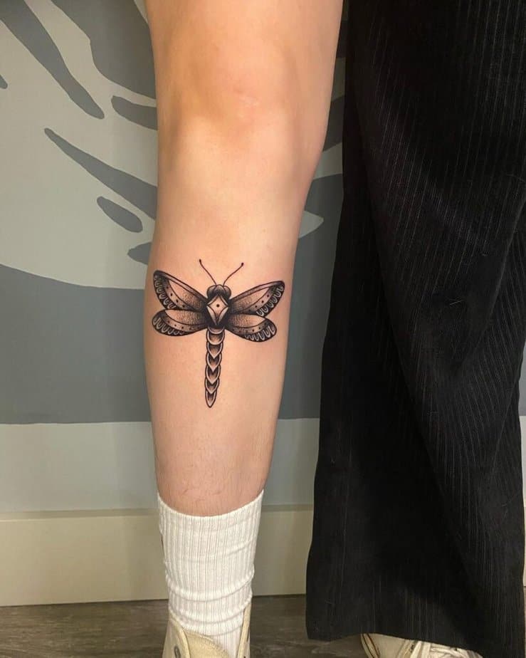A dragonfly tattoo on the shin