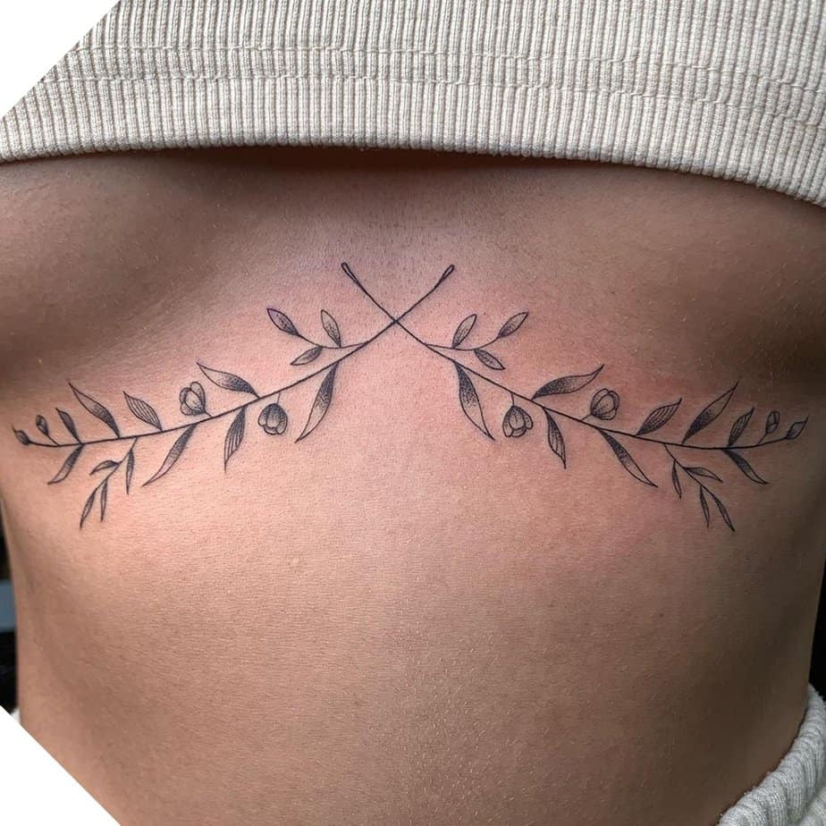 A fine-line floral sternum tattoo