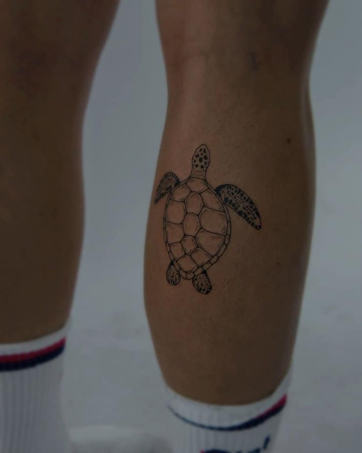 14. A fine-line sea turtle tattoo on the leg
