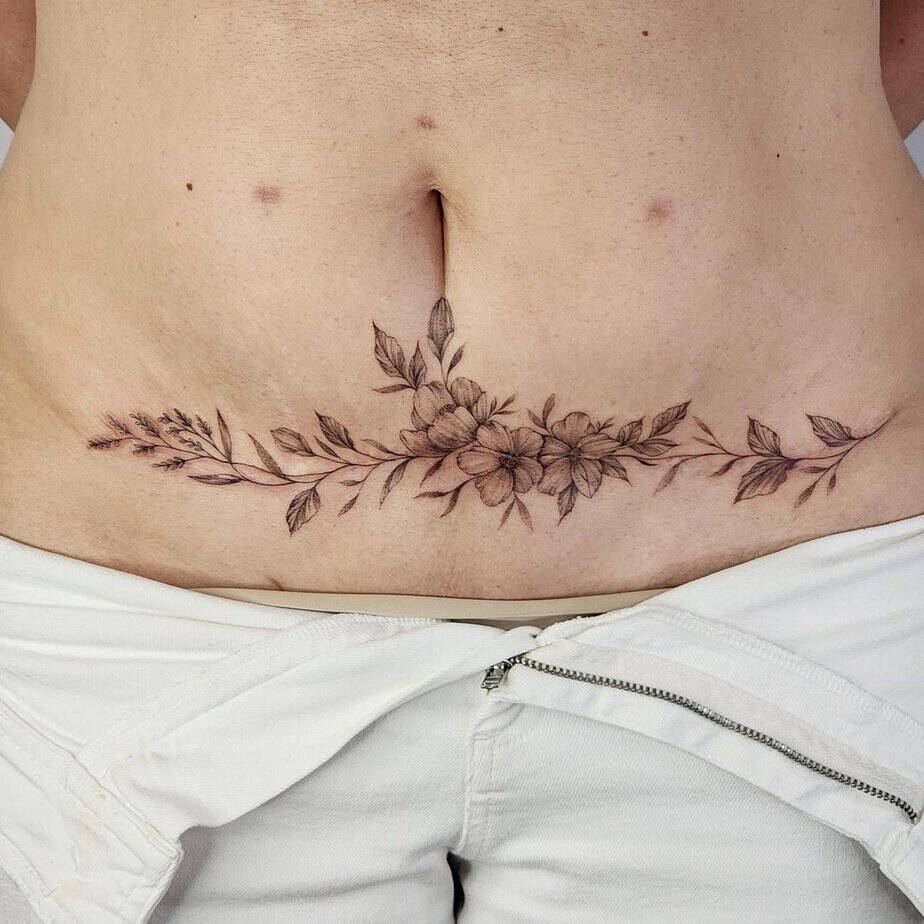 9. A fine-line tummy tuck tattoo
