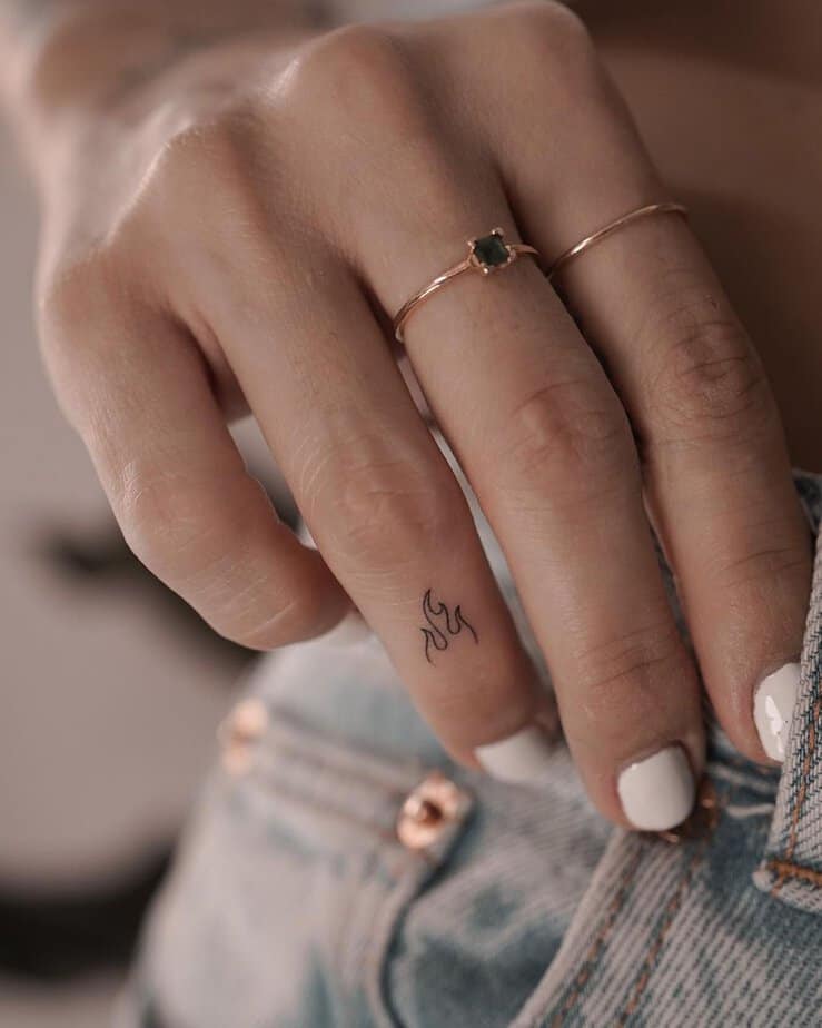 A fire tattoo on the finger