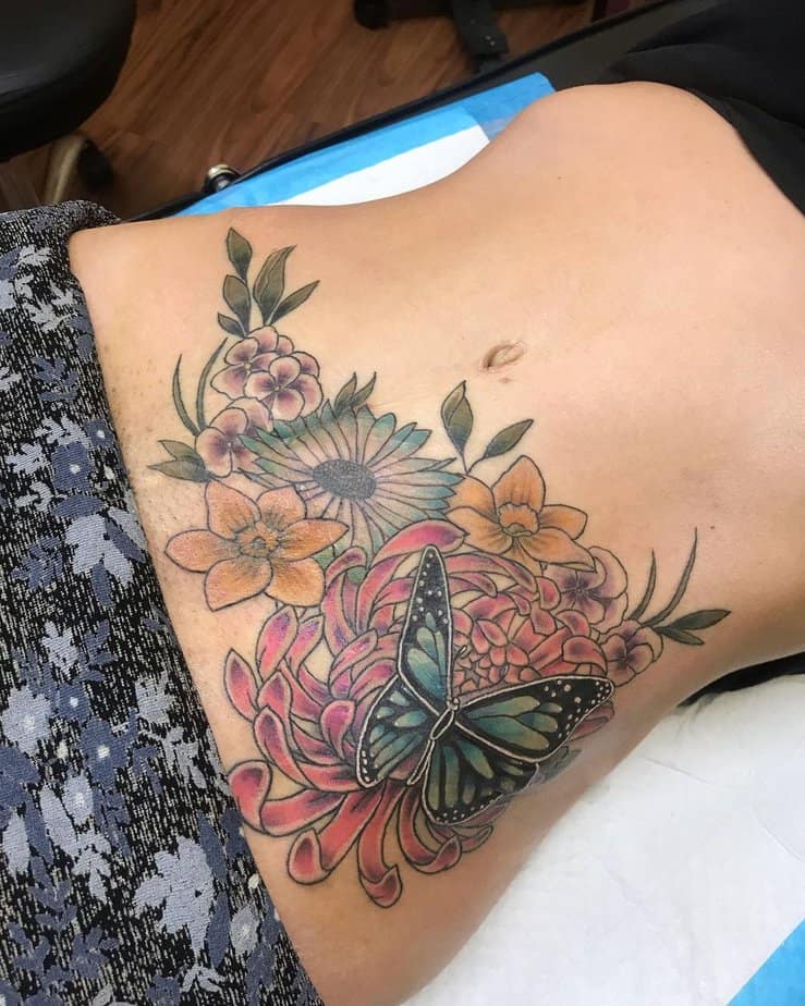 11. A floral tummy tuck tattoo
