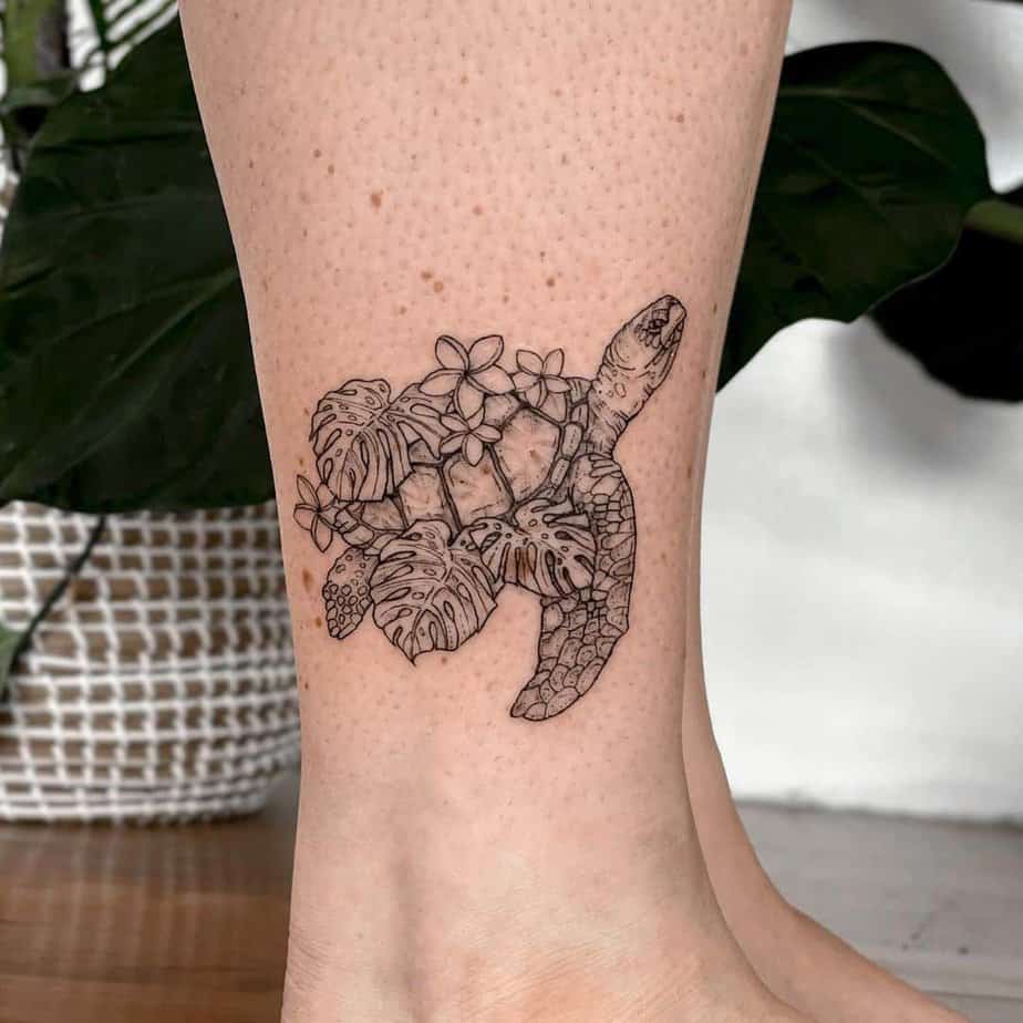 13. A flowy, floral sea turtle tattoo above the ankle
