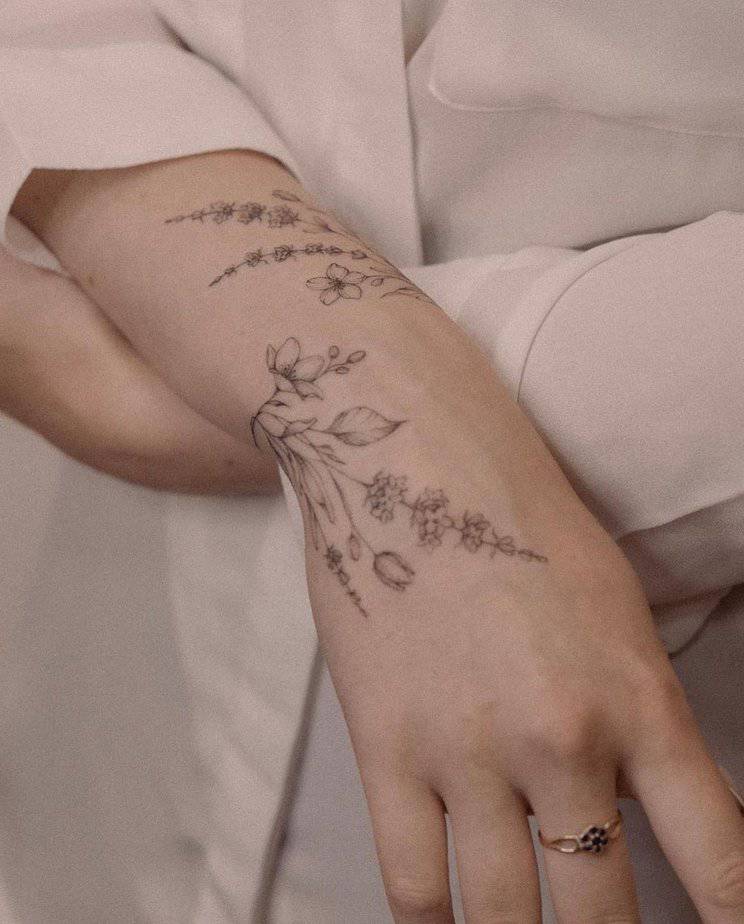 A flowy, floral tattoo that wraps around the wrist