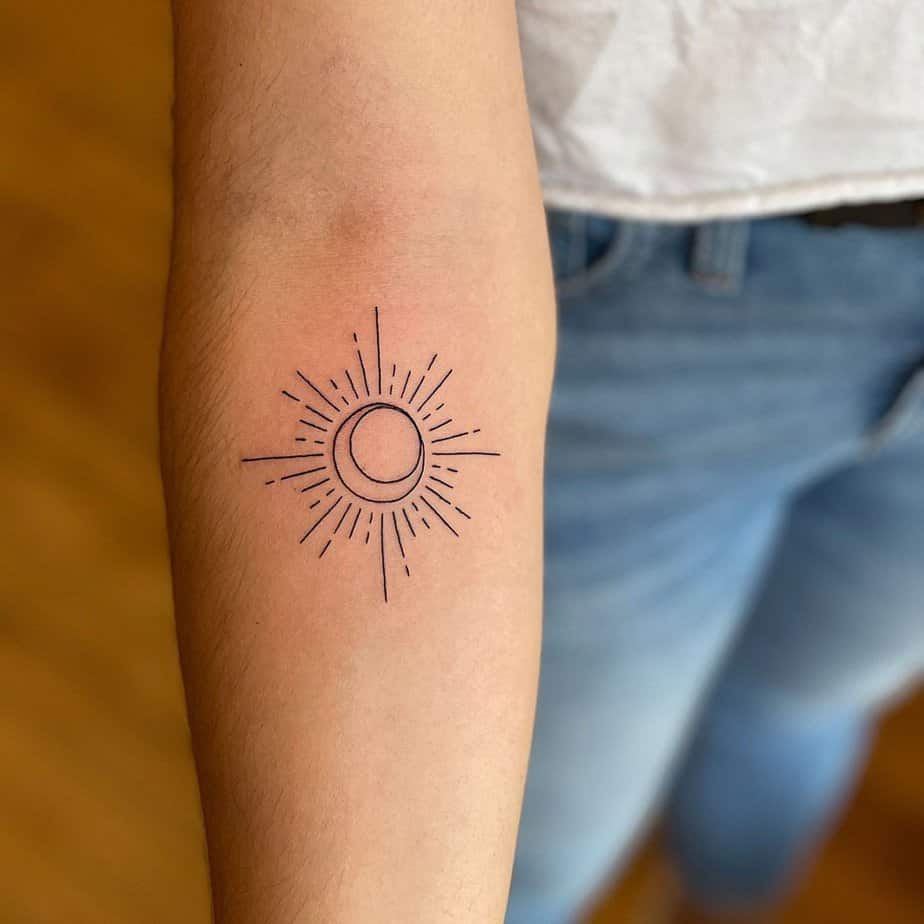 A geometric sun and moon tattoo