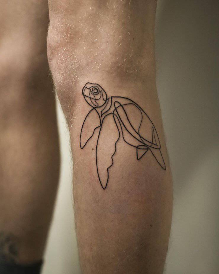 8. A line-art sea turtle tattoo on the leg
