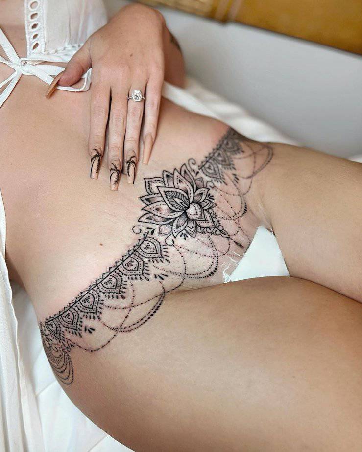 20. A lotus flower mandala tummy tuck tattoo
