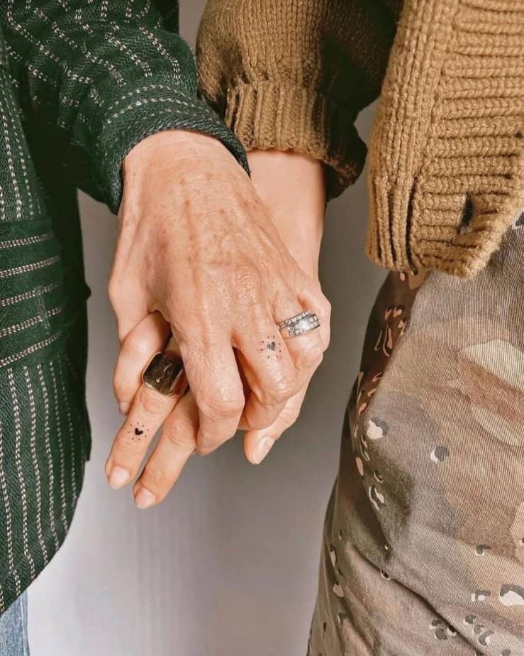 A matching heart tattoo on the fingers
