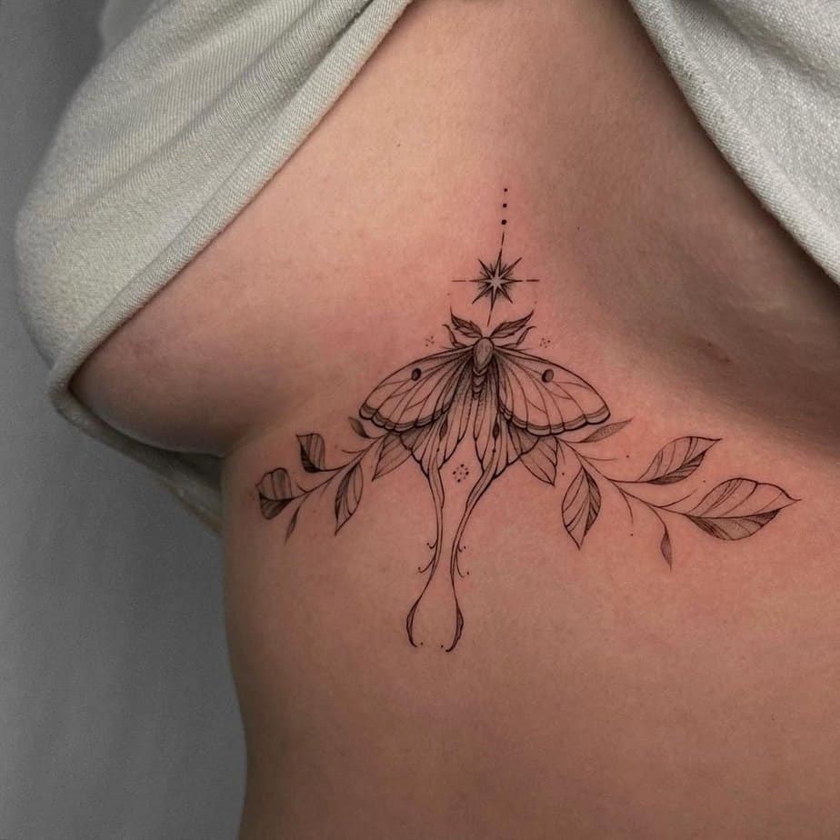 A moth middle chest tattoo