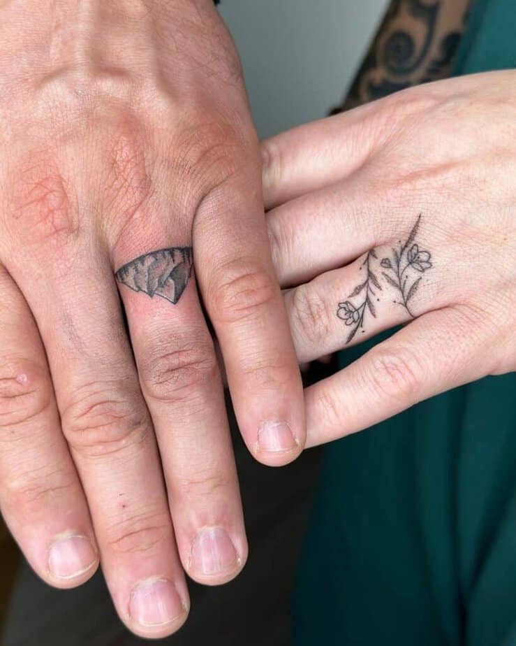 A mountain and a flower wrap ring tattoo