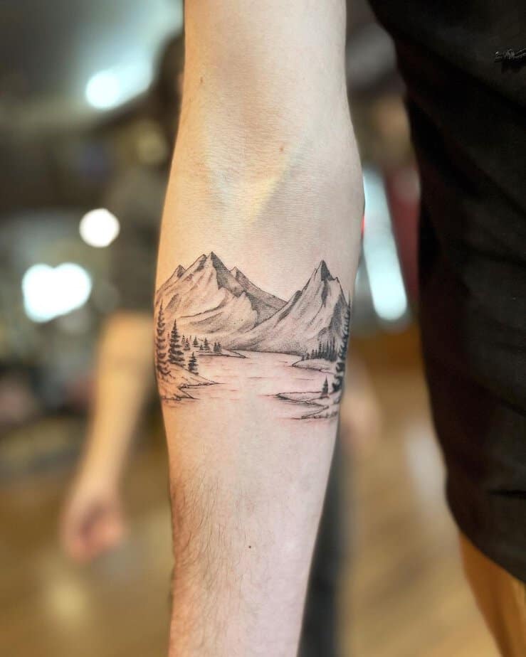 7. A mountain scenery tattoo
