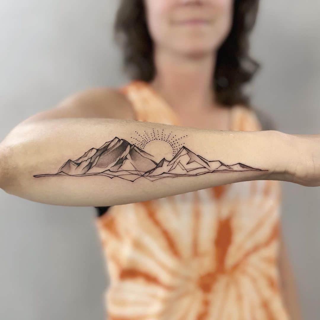 3. A mountain tattoo across the forearm
