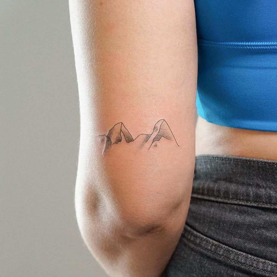 12. A mountain tattoo on the back of the arm
