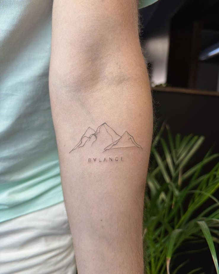 1. A mountain tattoo with a mantra