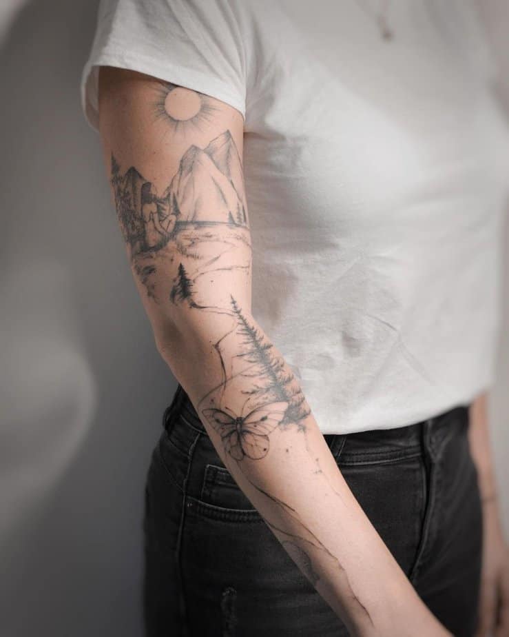 19. A mountain-themed tattoo sleeve
