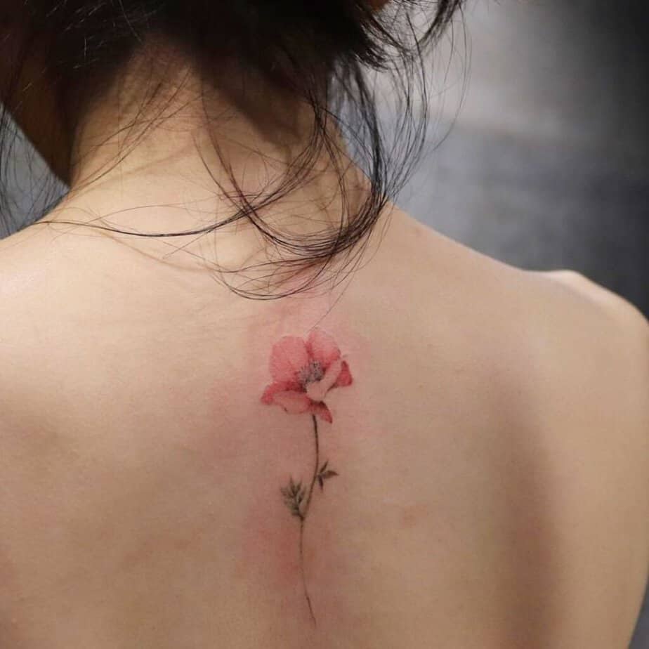 A poppy flower tattoo on the back