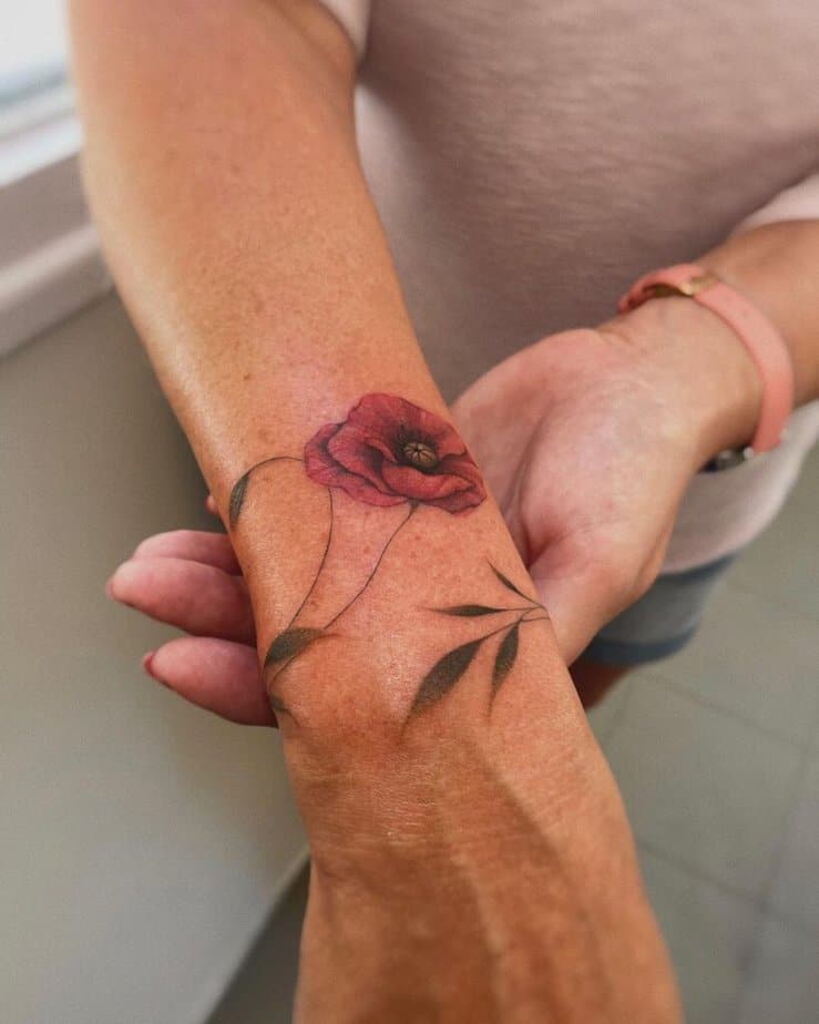 A poppy flower tattoo on the wrist