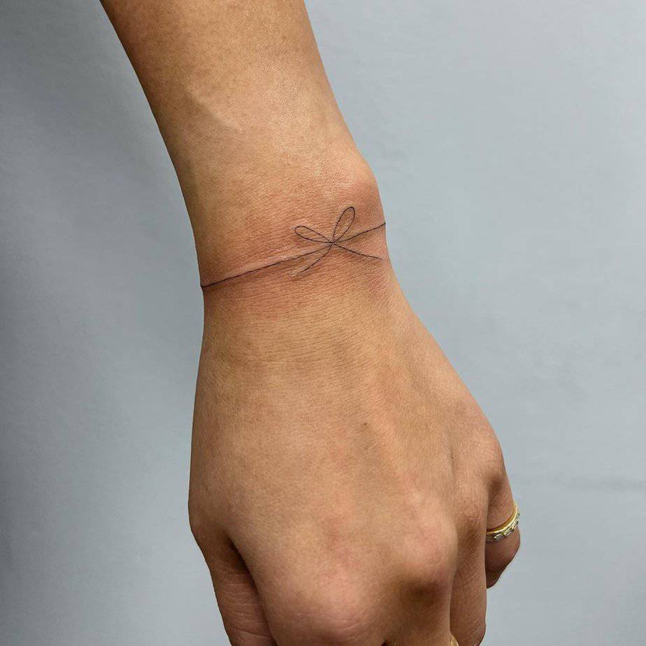 A ribbon tattoo around the wrist