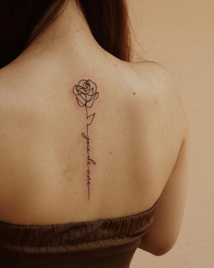 A rose spine tattoo with a mantra