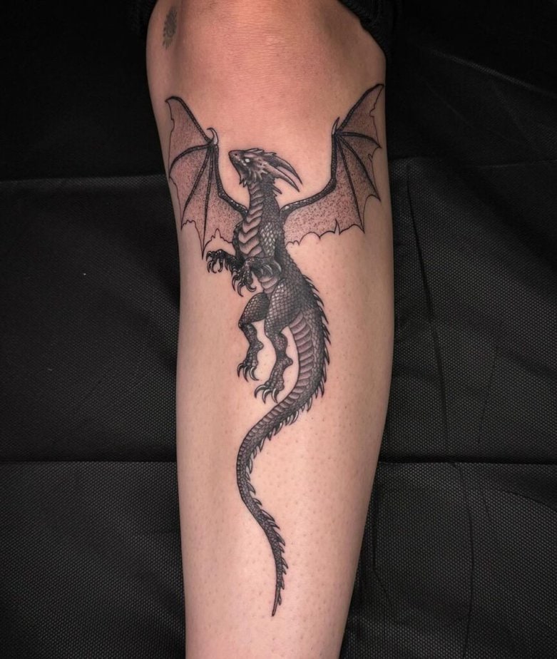 A tattoo of a dragon on the shin