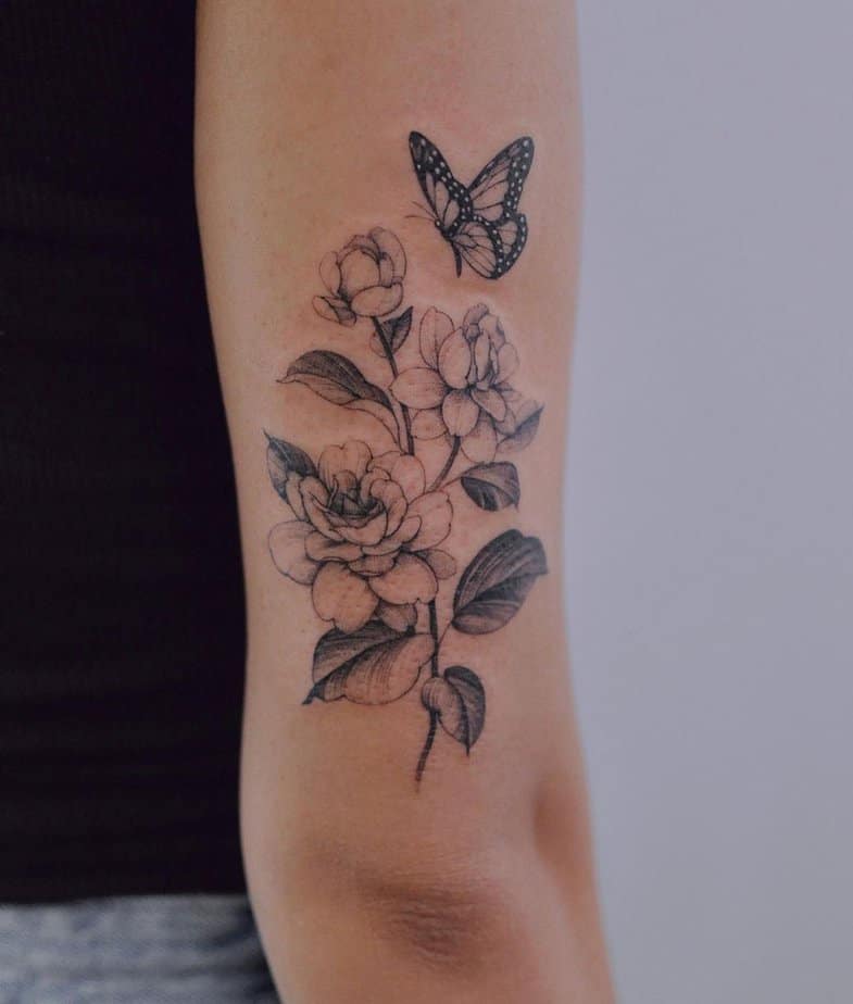 12. A tattoo of a jasmine flower and a butterfly
