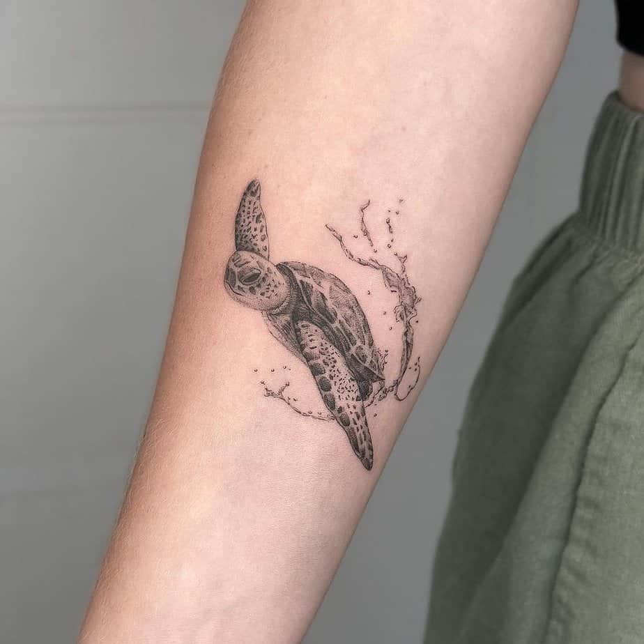 11. A tattoo of a sea turtle splashing in the water
