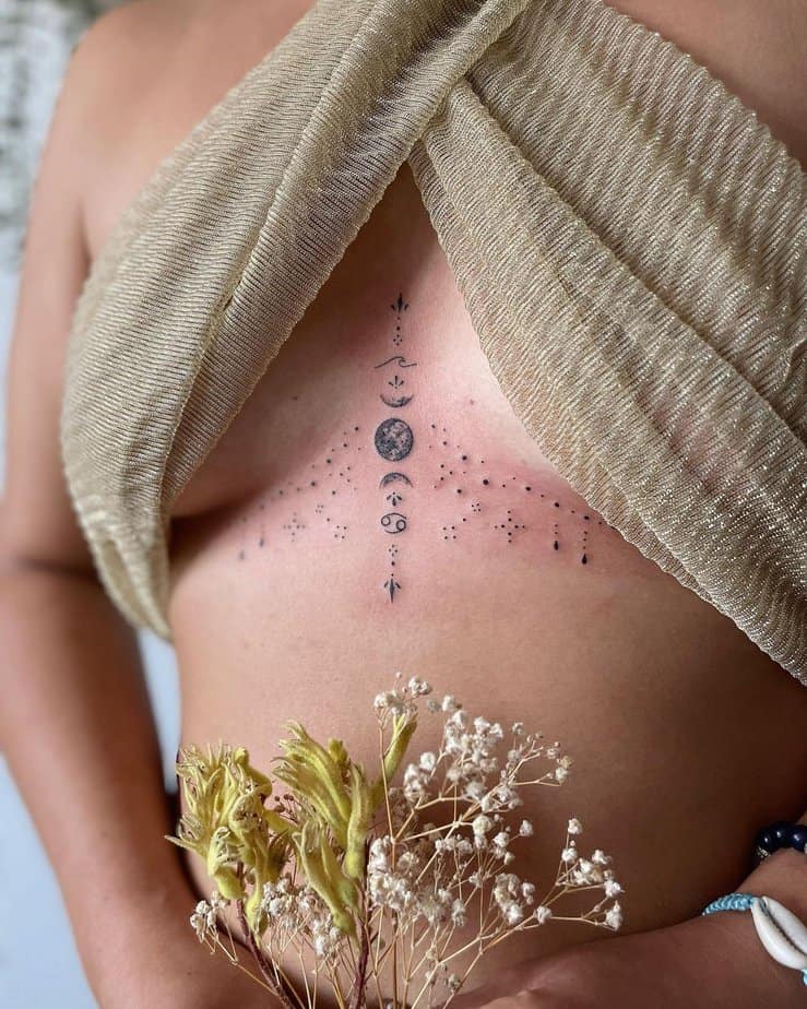 A tattoo of sternum ornaments with moon phases