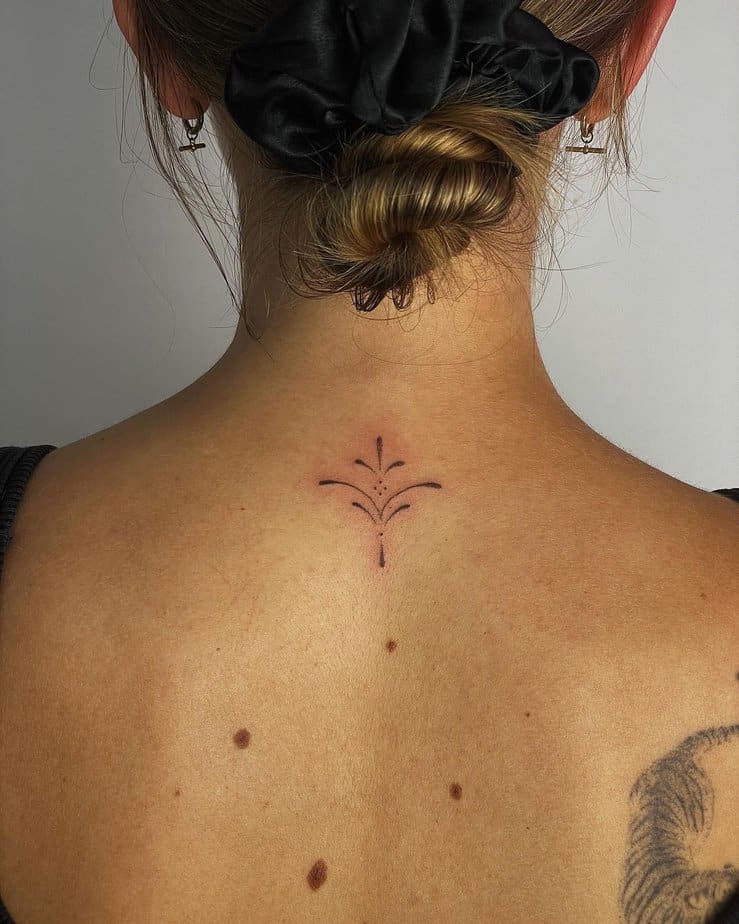 15. A tiny ornamental trap tattoo

