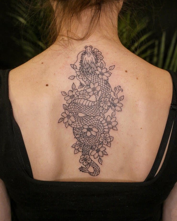 12. A trap tattoo of a dragon with flowers
