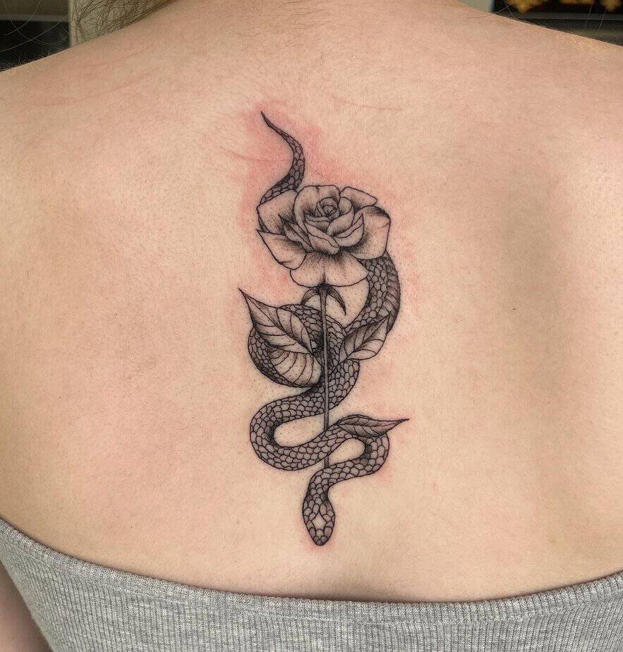 14. A trap tattoo of a rose and a snake
