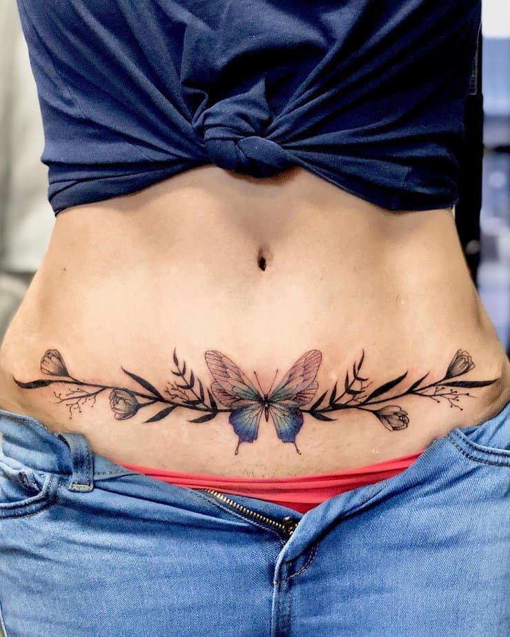 6. A tummy tuck tattoo with a colorful butterfly
