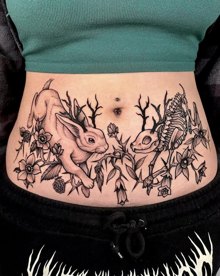 14. A tummy tuck tattoo with bunnies and flowers
