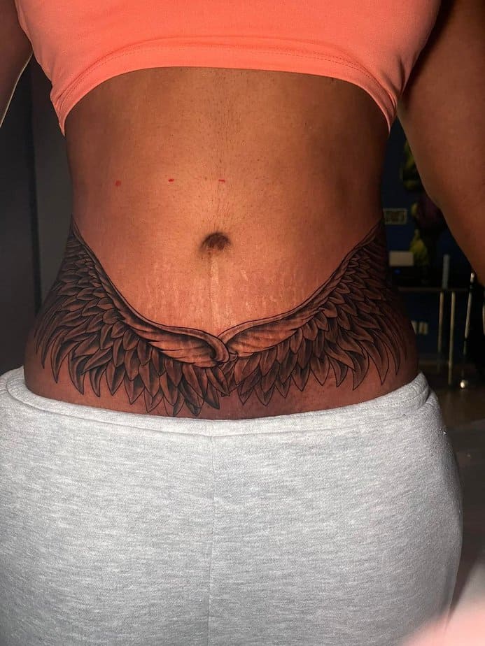 5. A tummy tuck tattoo with wings
