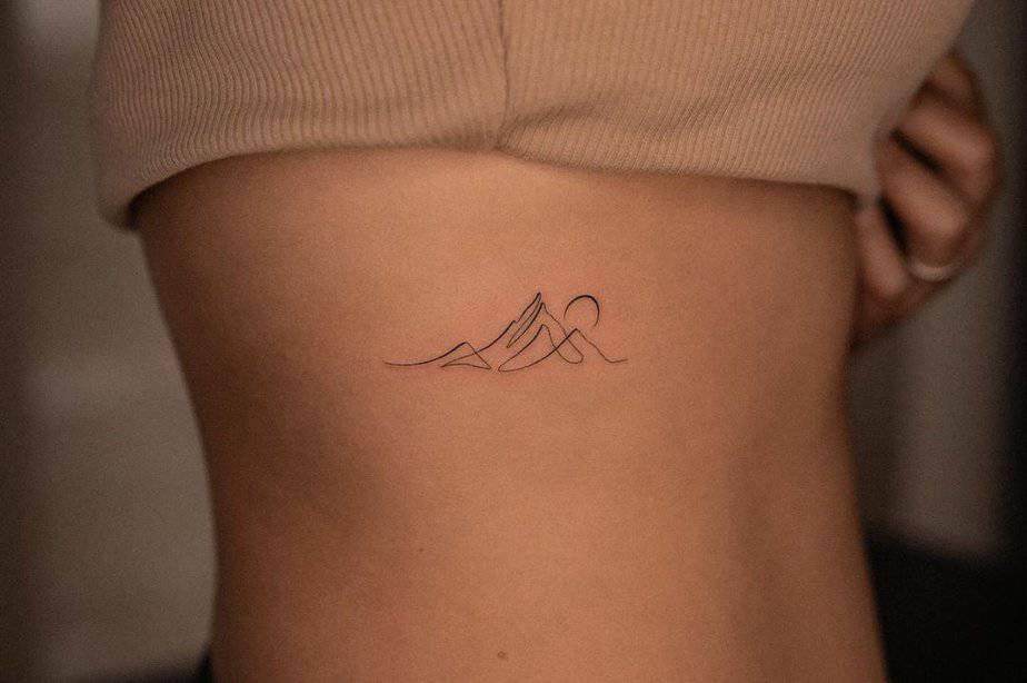 6. An abstract mountain tattoo on the ribcage

