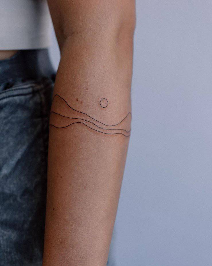 4. An abstract mountain tattoo with a moon
