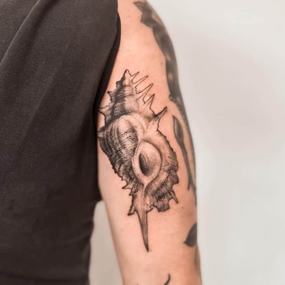 3. An alabaster shell tattoo on the upper arm
