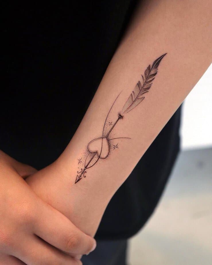 4. An arrow and feather Sagittarius tattoo
