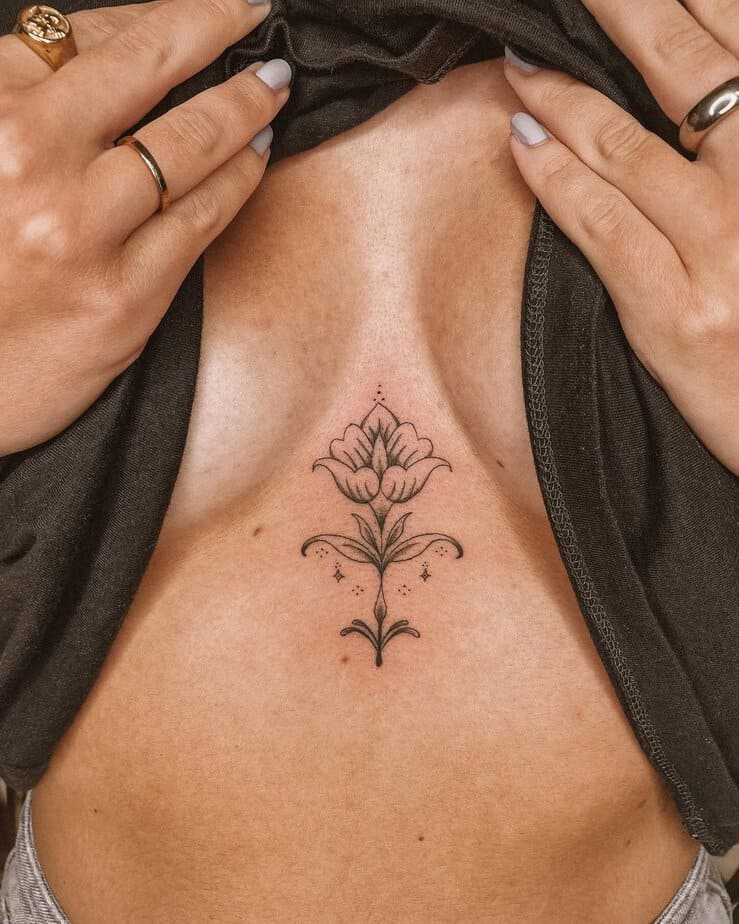 An ornamental flower sternum tattoo