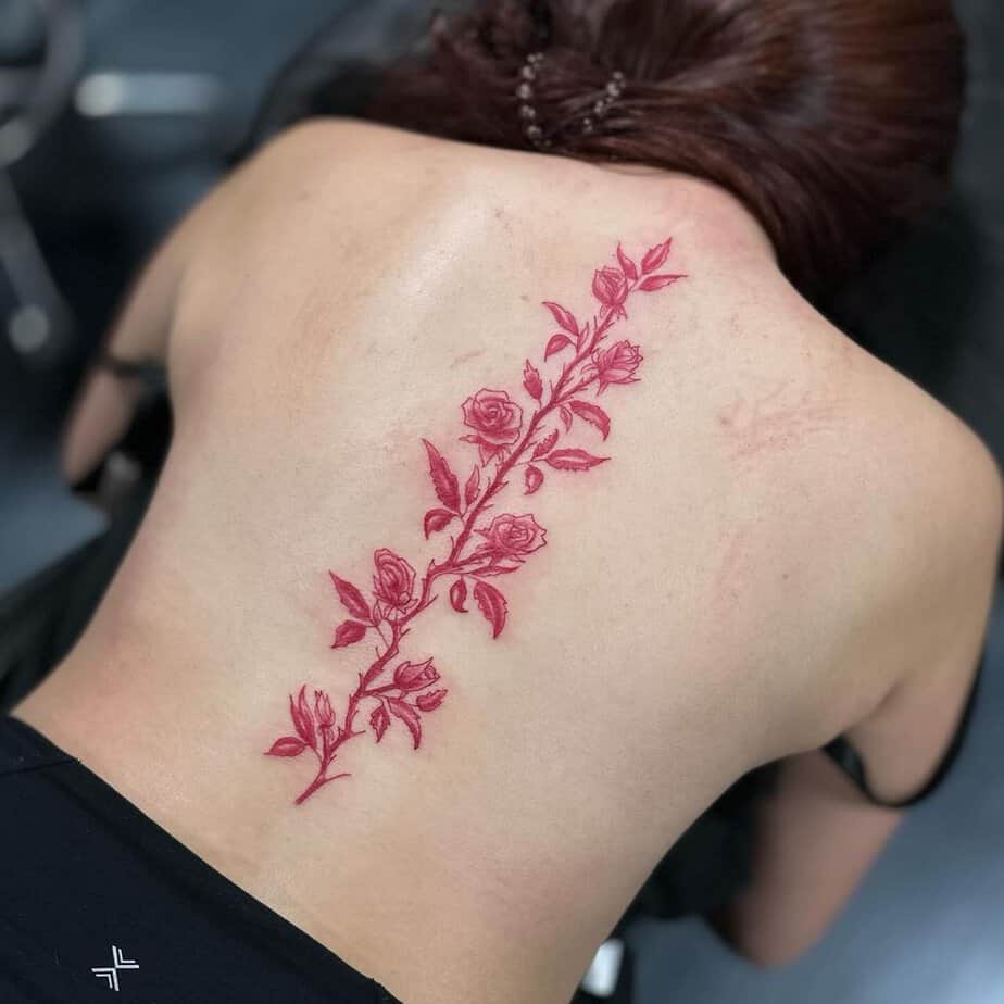 Colorful vine back tattoo