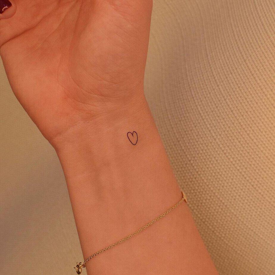 7. A delicate and dainty heart tattoo on the wrist 