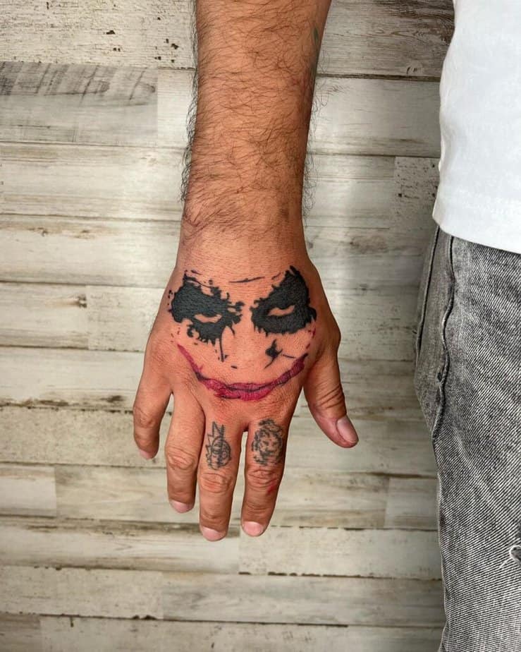 14. A small and simple Joker hand tattoo 